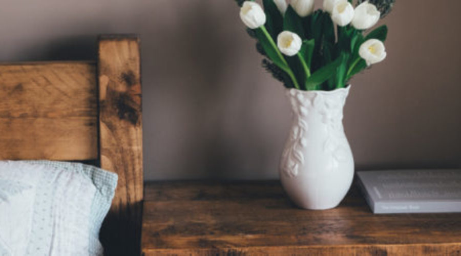 bedside table with vase staging